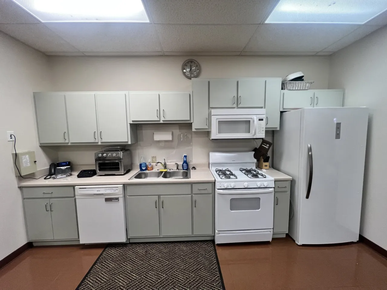 Painted cabinets in an office break-room kitchenette, cabinet work by Drop Zone Painting
